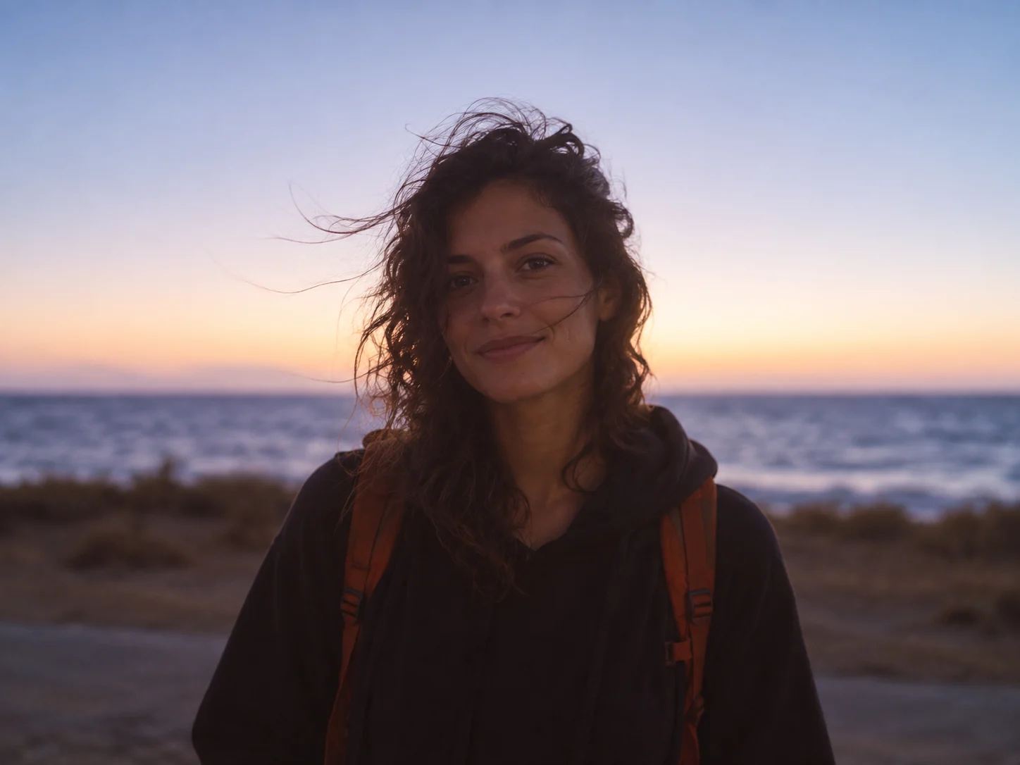Person looking toward the ocean at sunset