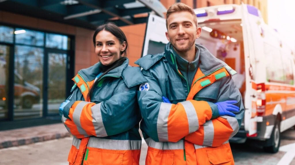 First responders standing beside an ambulance