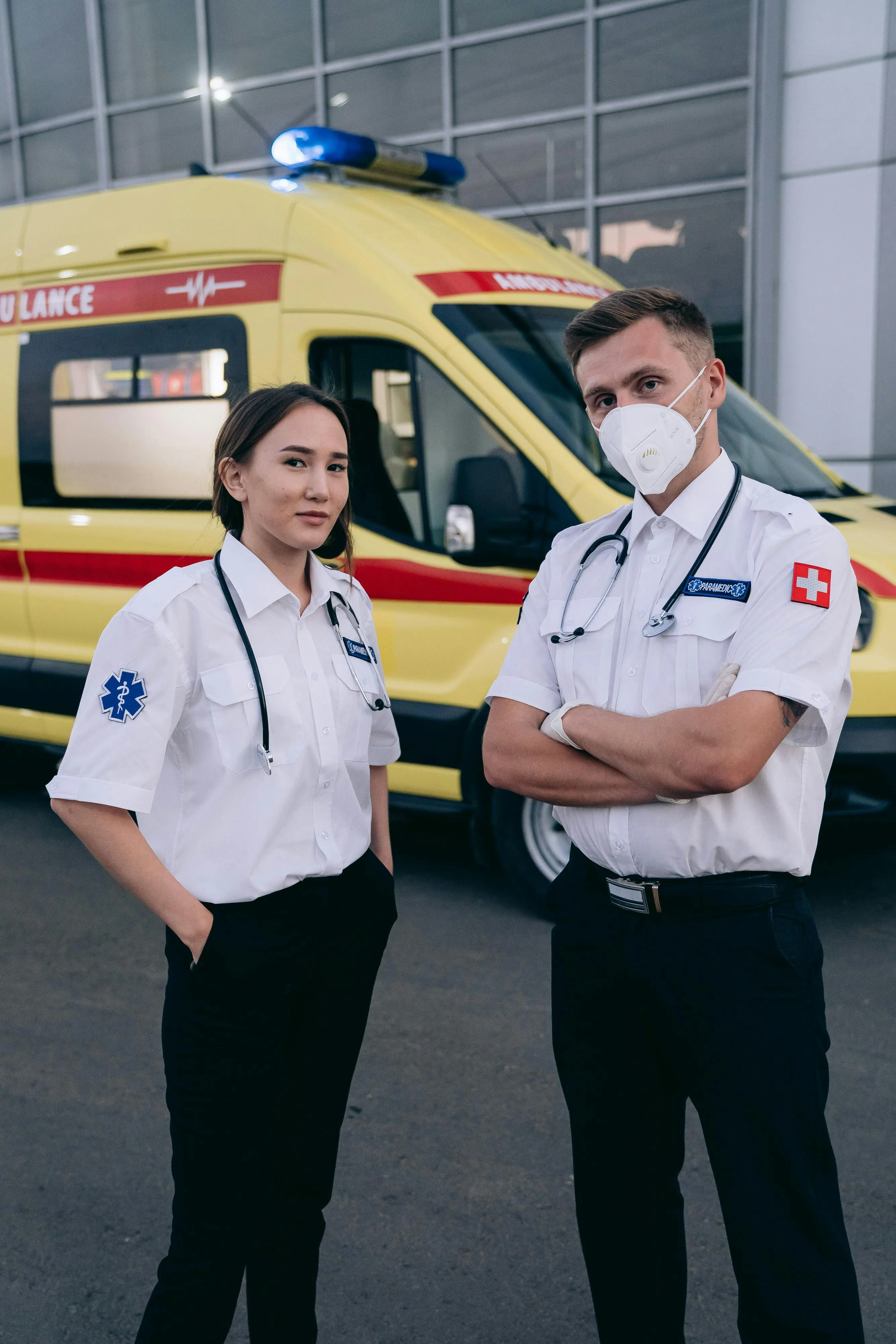 Emergency responders standing beside an ambulance